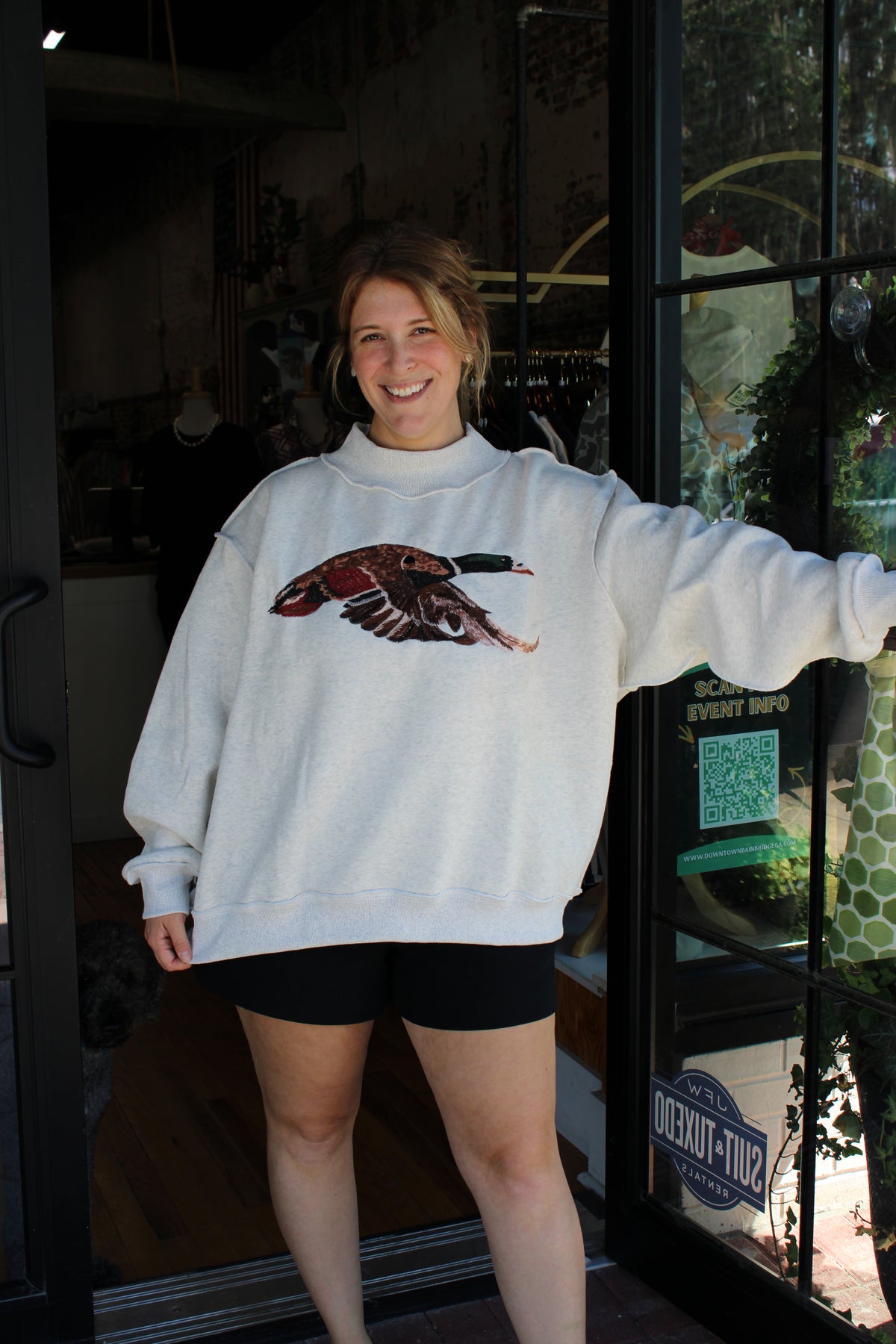 woman wearing ray mock neck sweatshirt with embroidered mallard duck on the front