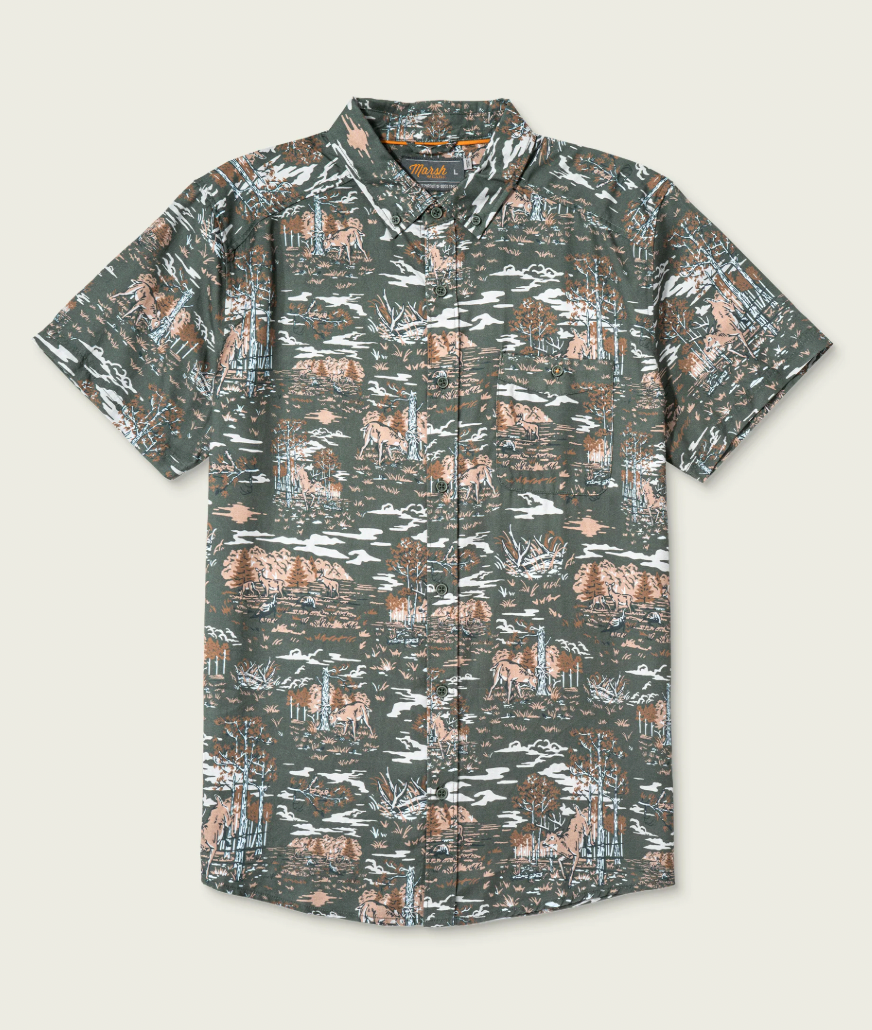 A short-sleeve button-up camp shirt with an all-over camouflage-style print featuring brown deer, white birds, and light blue foliage on a dark olive green background, shown flat against a light beige backdrop.