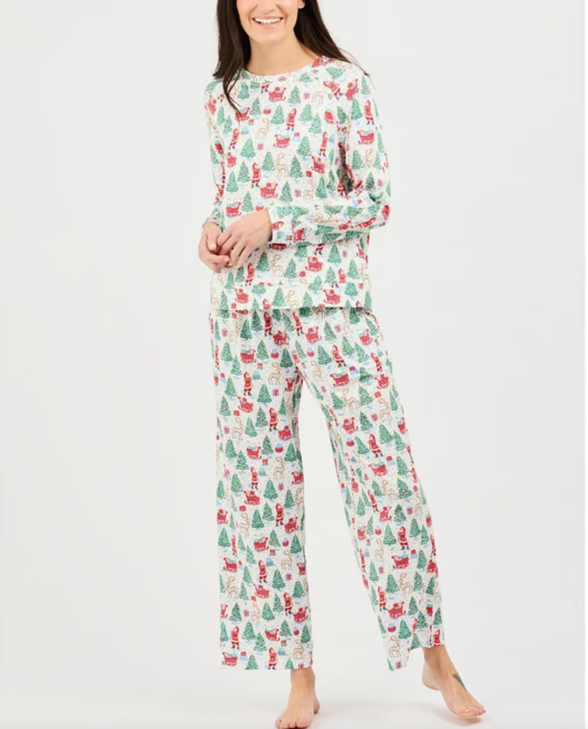 Woman wearing a Christmas-themed pajama set on a white background
