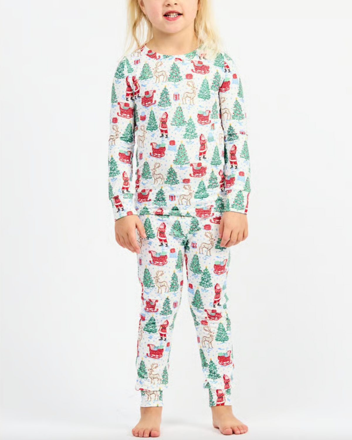 Child wearing Christmas-themed pajamas on a white background