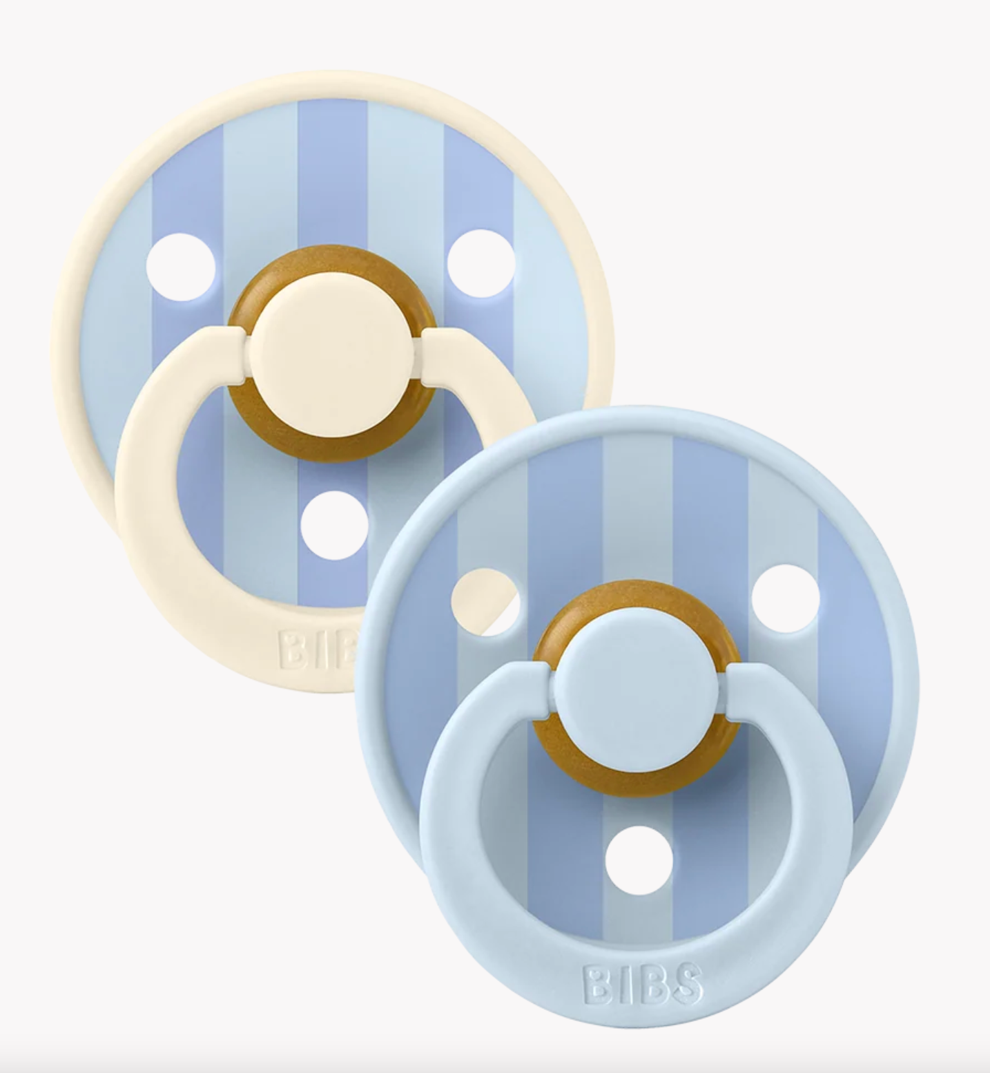Two BIBS pacifiers with light blue and cream silicone rings, featuring light blue and blue vertical stripes on the shields with gold accents, shown on a light gray background.
