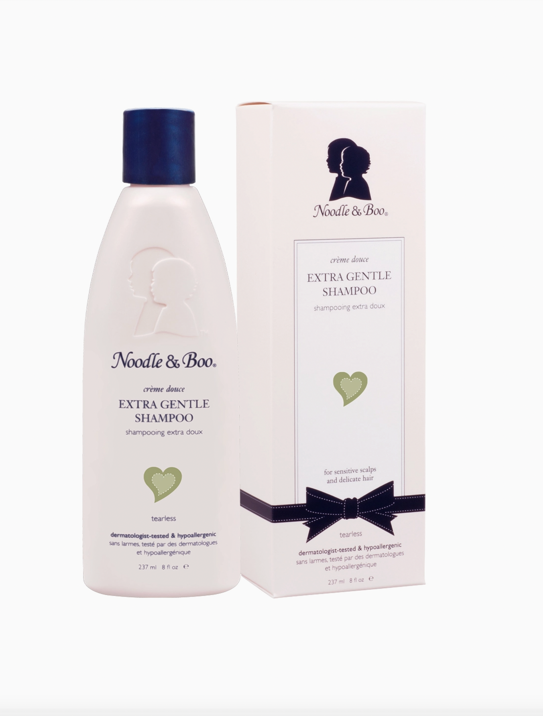 Noodle & Boo Extra Gentle Shampoo bottle in white with a dark blue cap, shown next to its matching white packaging box with a dark blue ribbon and logo.