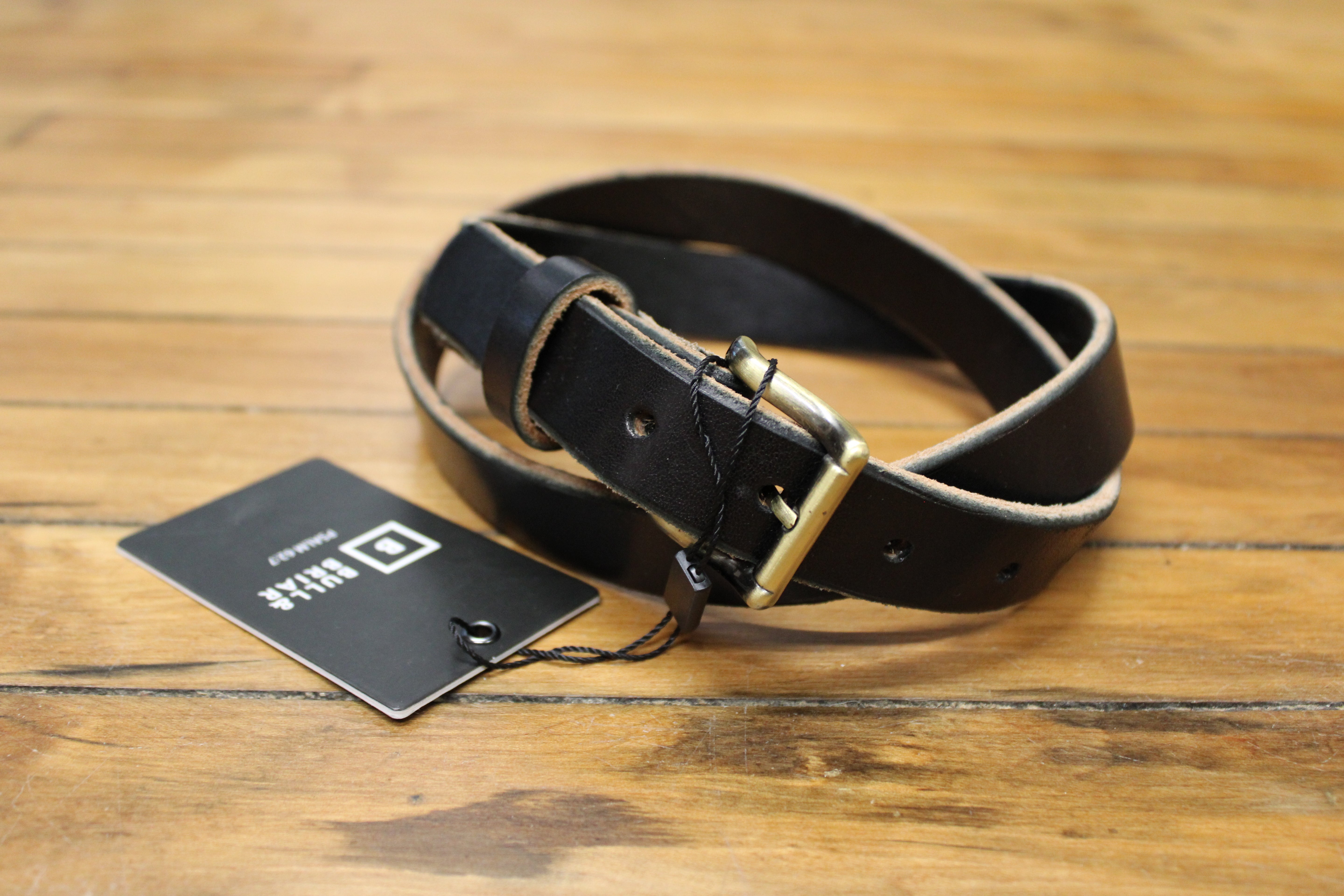 A black leather belt with a buckle