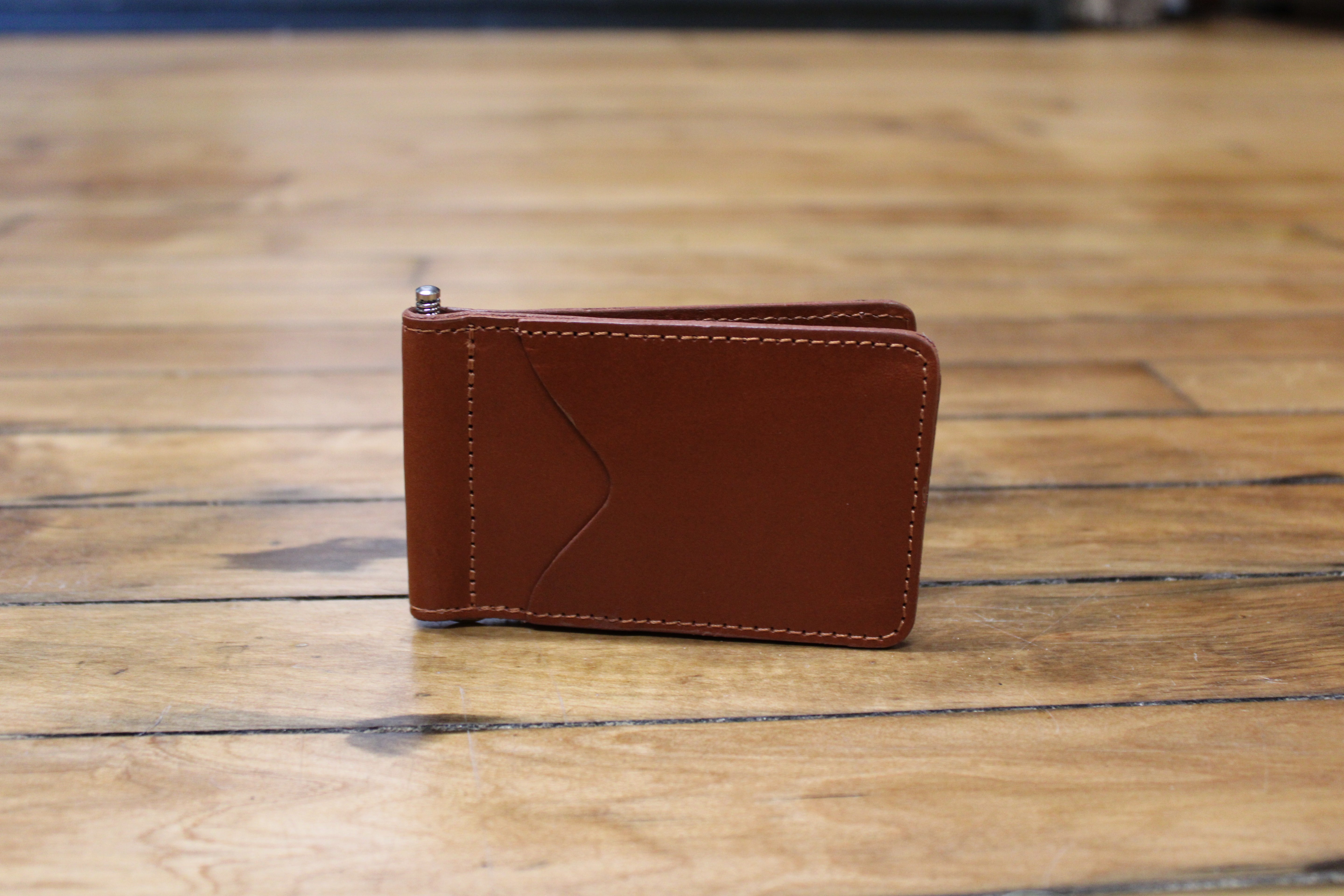 A brown leather front pocket wallet with a minimalist design