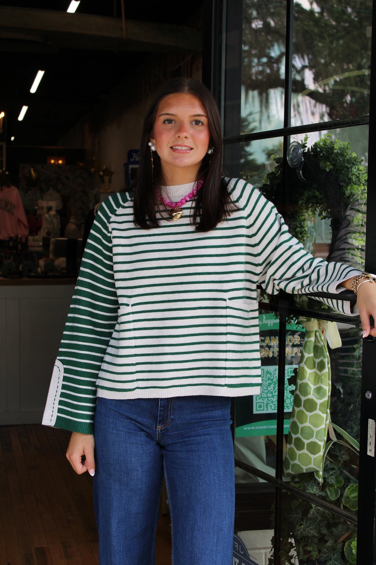 woman wearing a white and green striped sweater