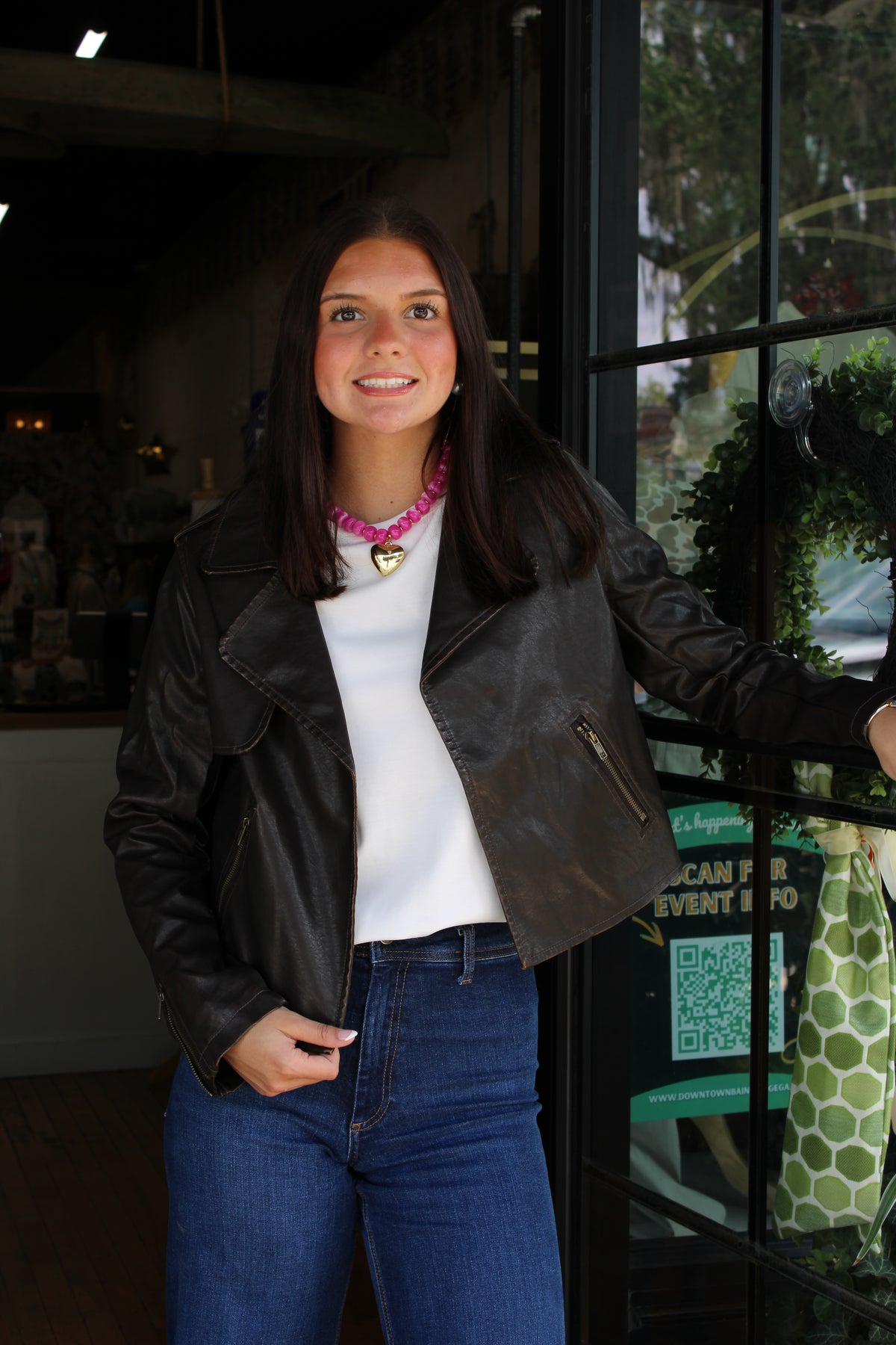 woman wearing a distressed brown leather jacket