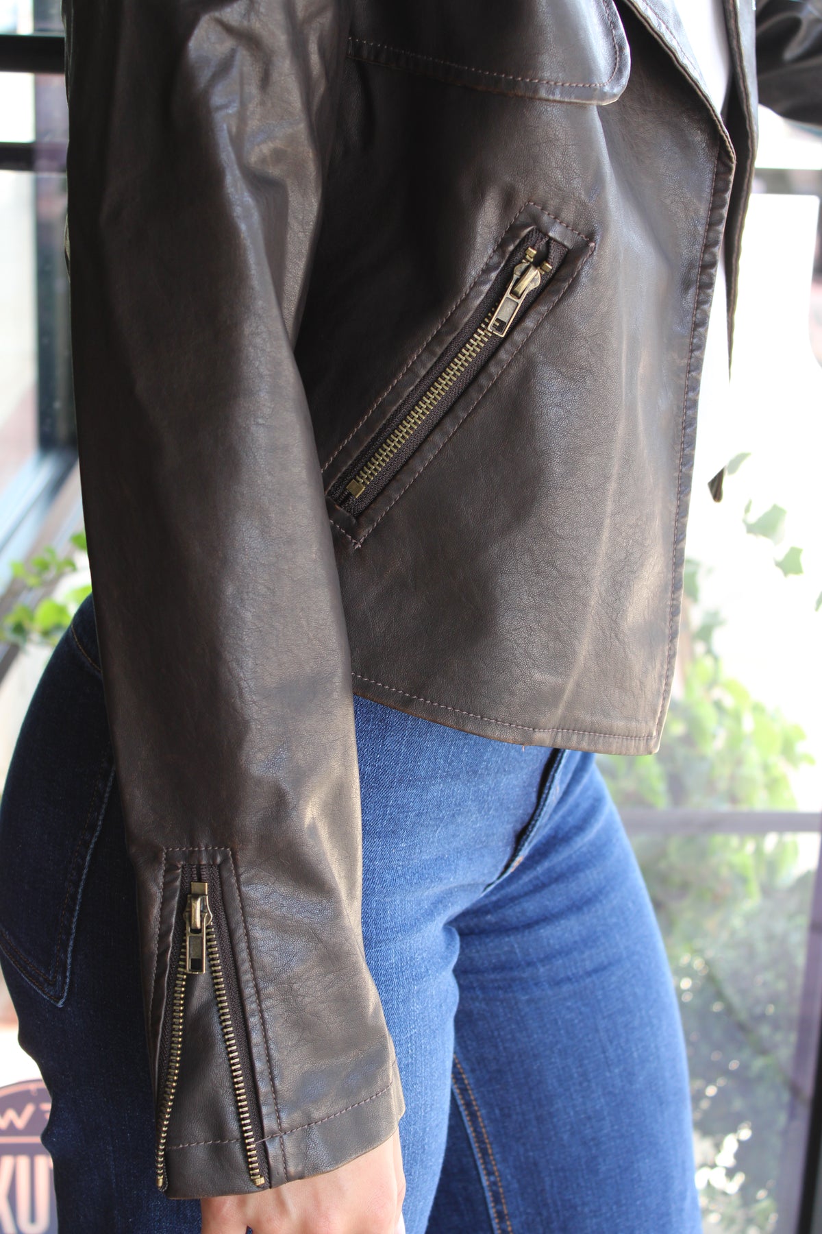 arm and pocket gold zipper detailing on a leather jacket