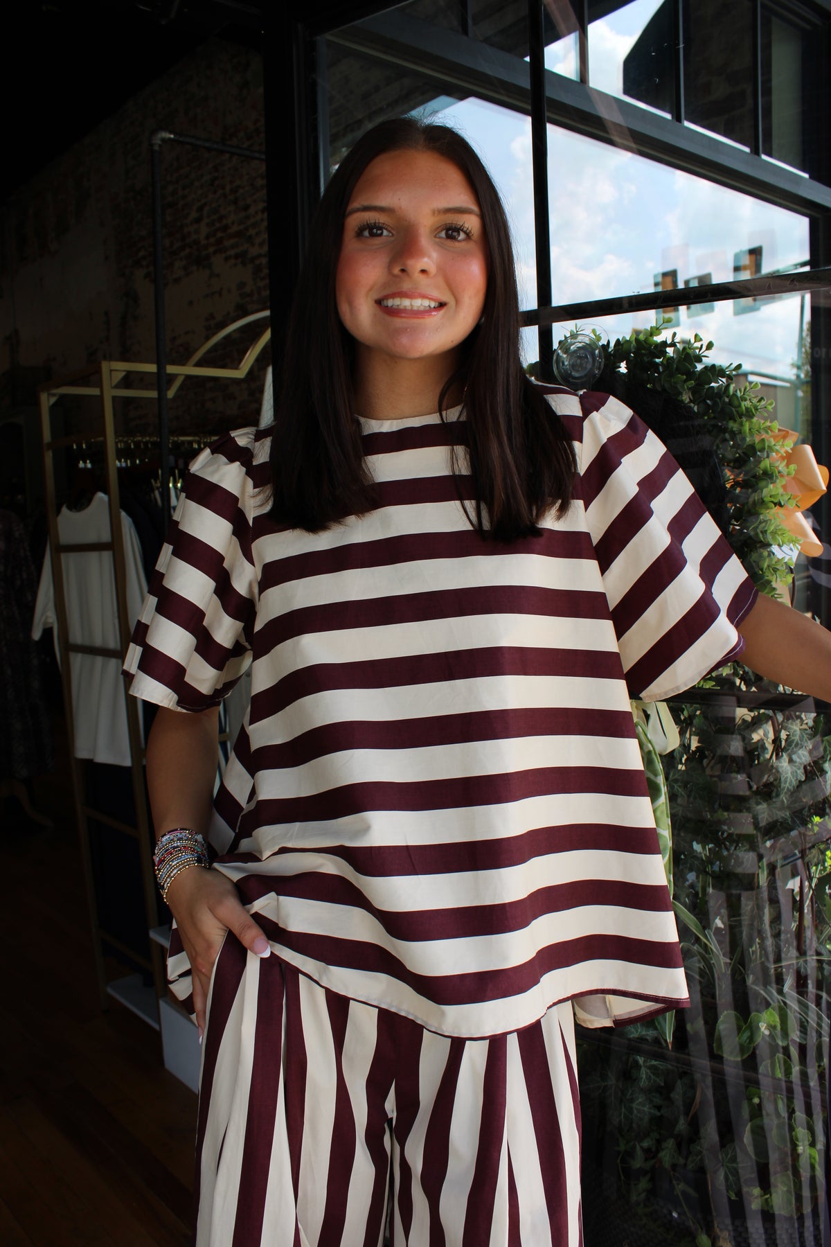 woman wearing maroon and white stripe top with matching pants