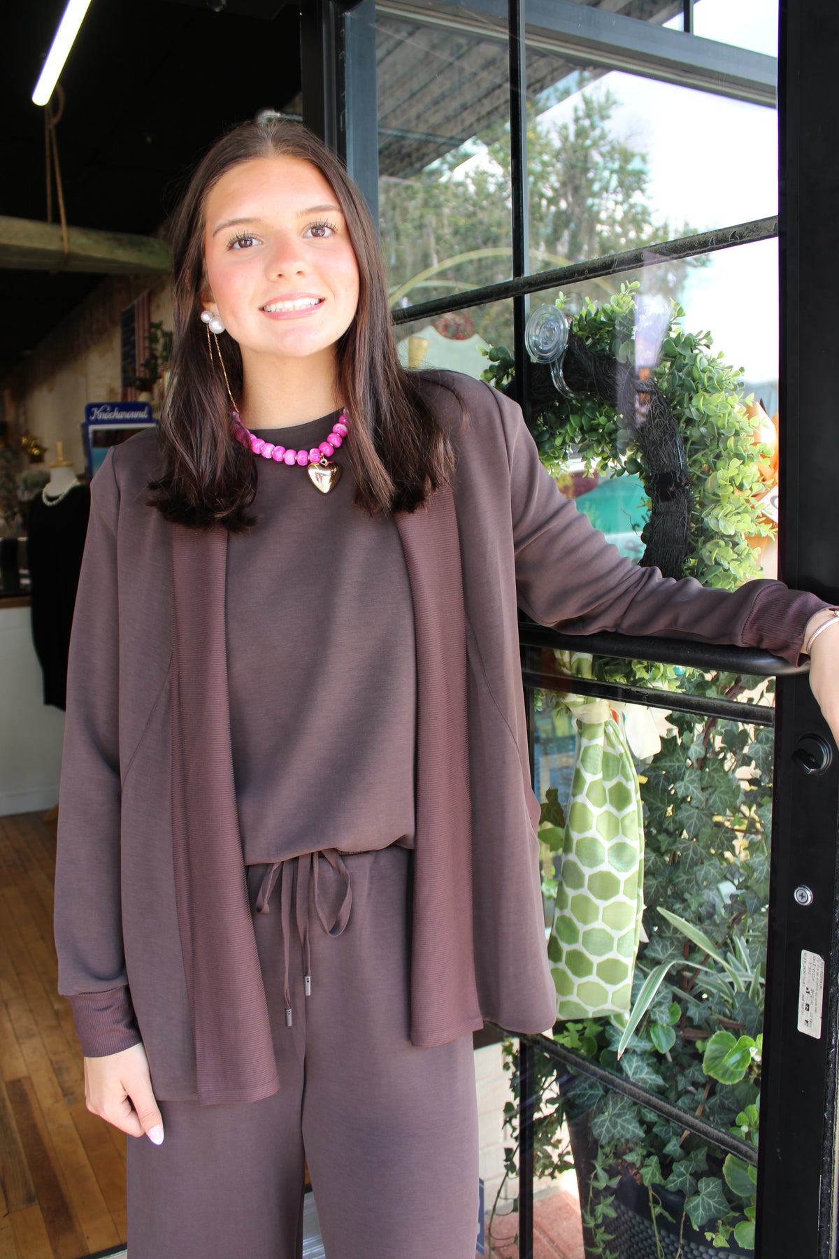 woman wearing a brown cardigan set with matching top and pants