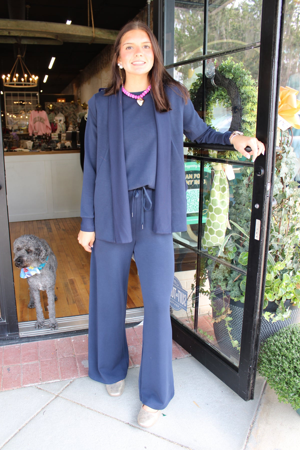 woman wearing navy blue set including top, pants, and cardigan