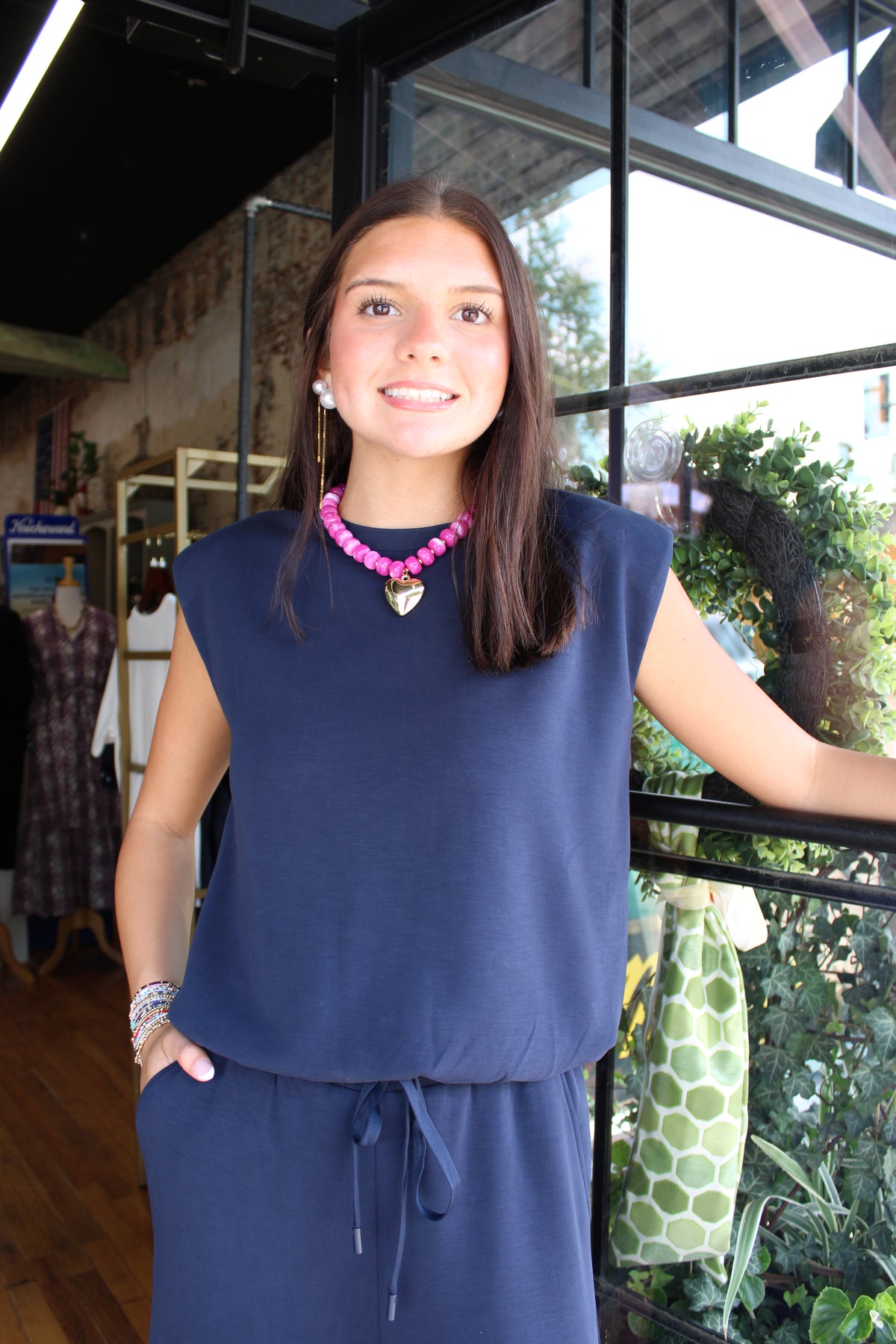 woman wearing navy blue sleeveless top with matching pants 