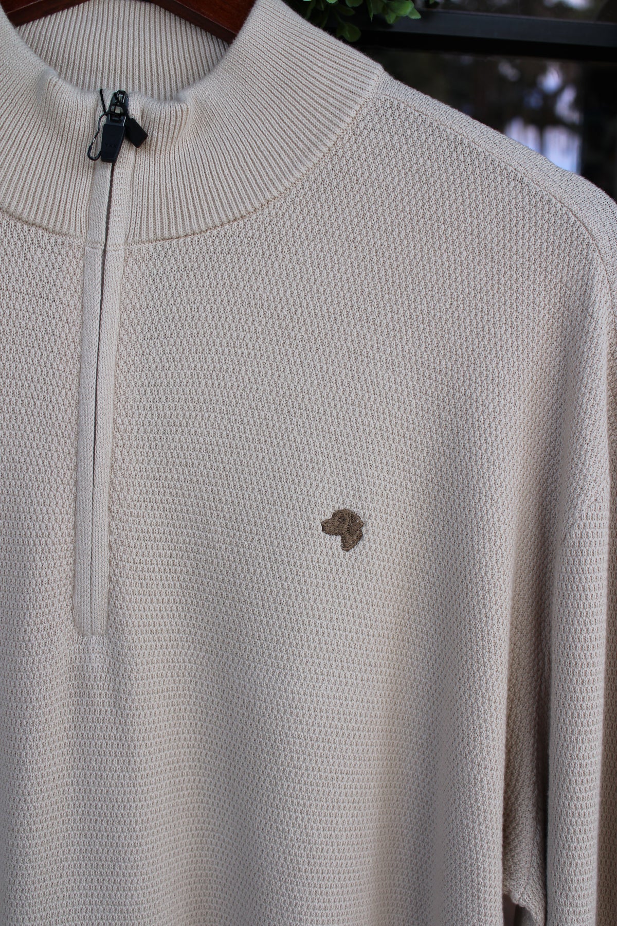 brown dog logo on an oatmeal colored pullover