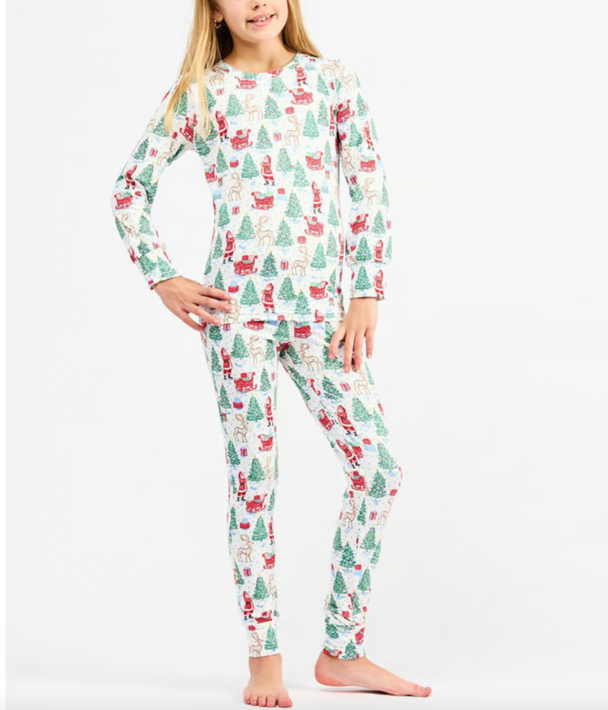 Child wearing a Christmas-themed pajama set on a white background
