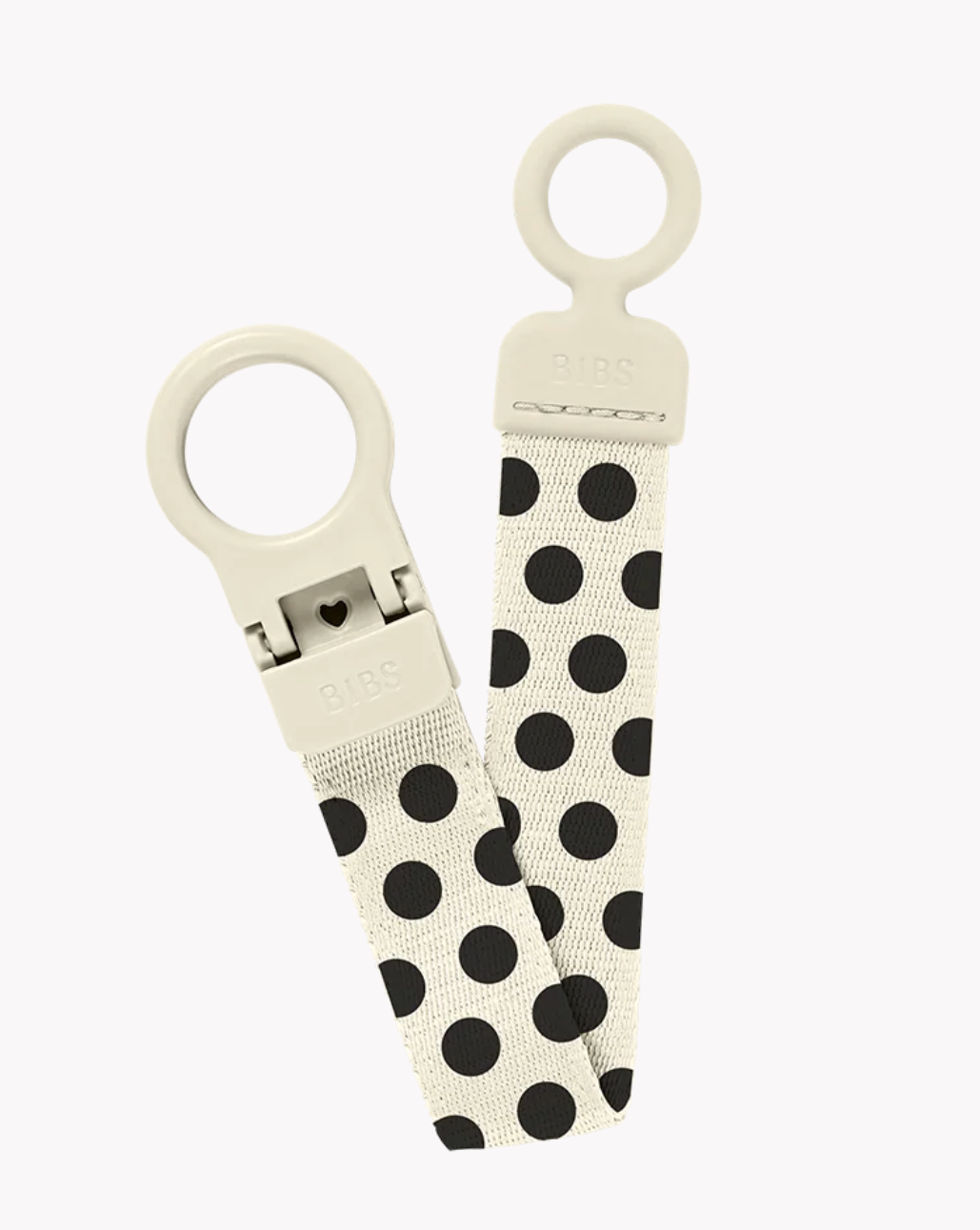 A pair of B&BS brand keychains featuring a cream-colored plastic ring and clasp with a cream fabric strap decorated with black polka dots, set against a plain light gray background.