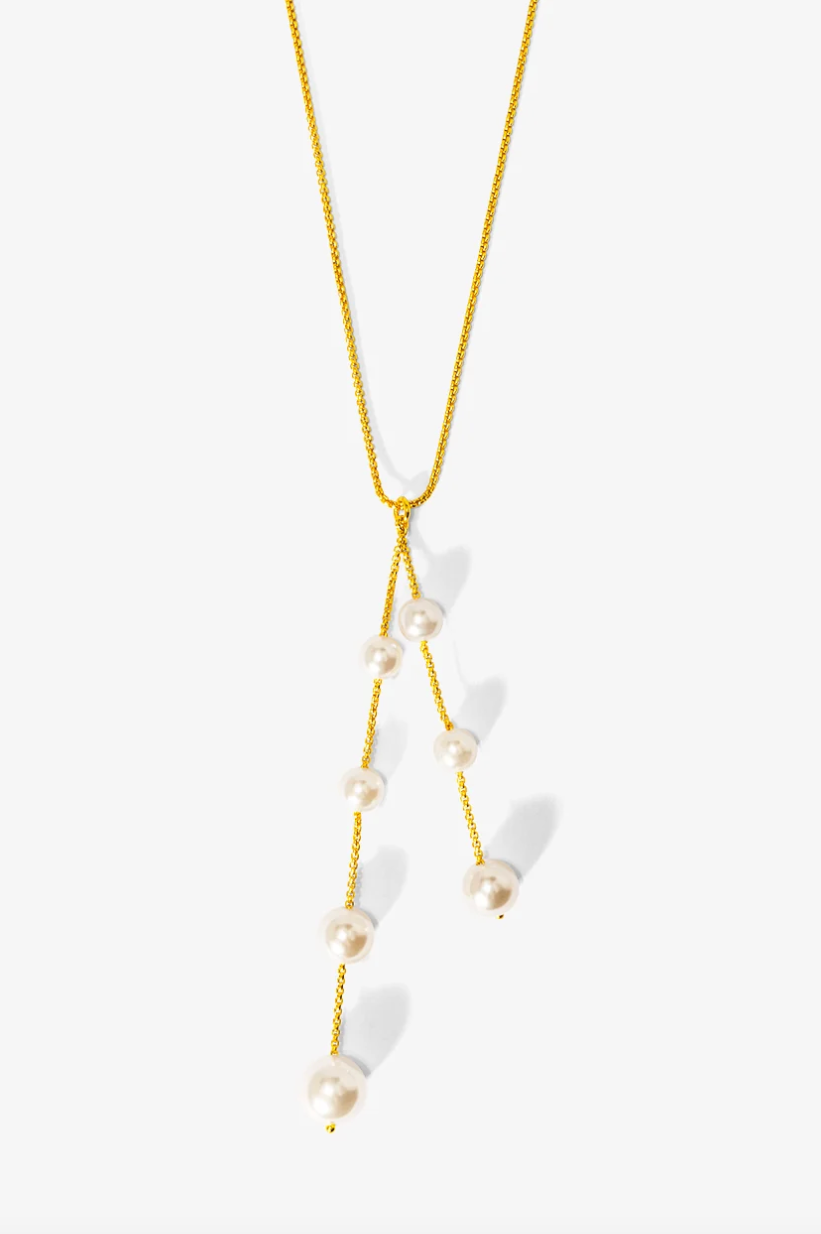 A gold chain necklace featuring a Y-shaped dangle design with small white pearl beads, photographed against a clean white background.