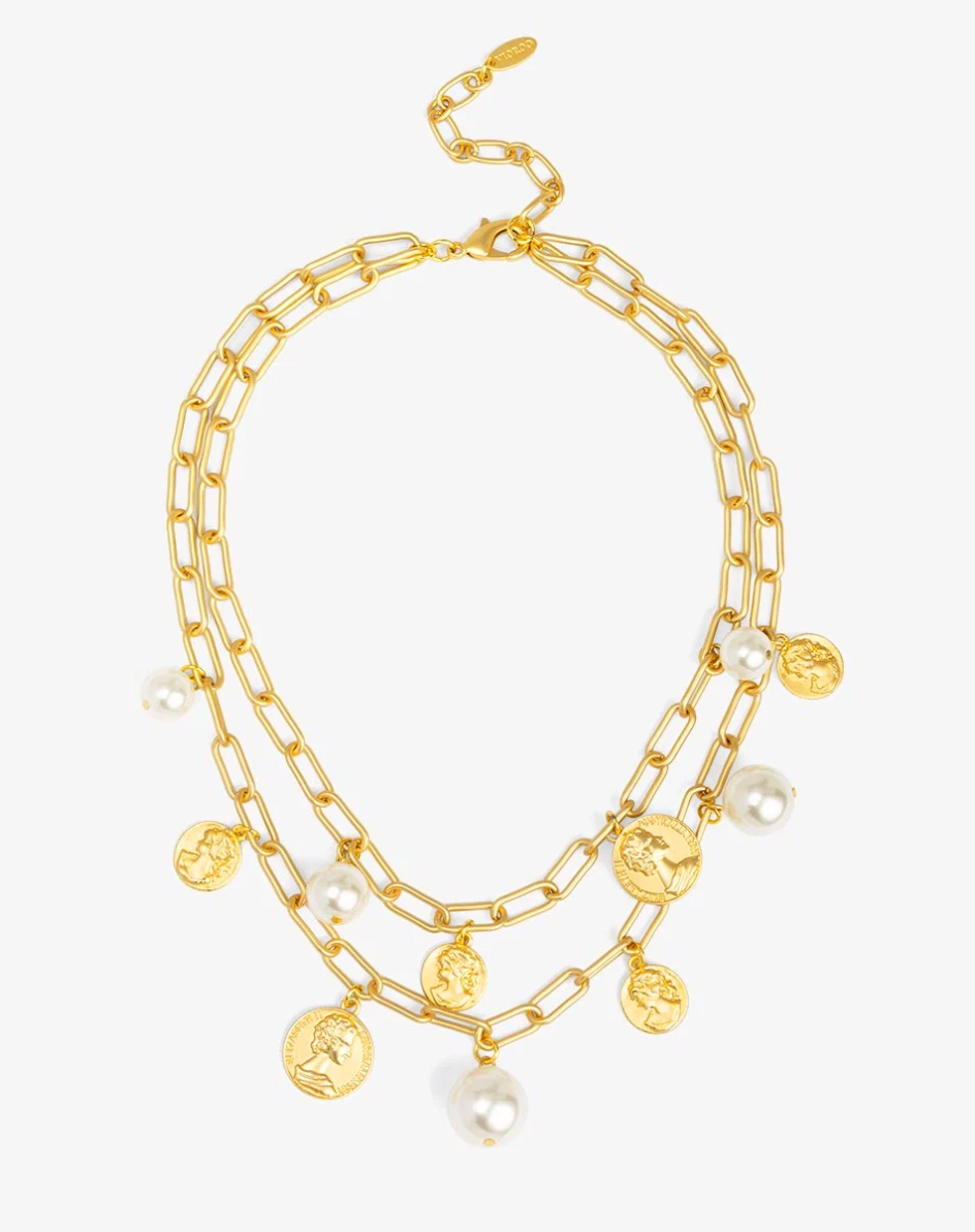 A gold-tone multi-strand necklace featuring a chunky link chain, delicate chain layers, small gold coin charms, and white pearl beads, displayed on a clean white background.