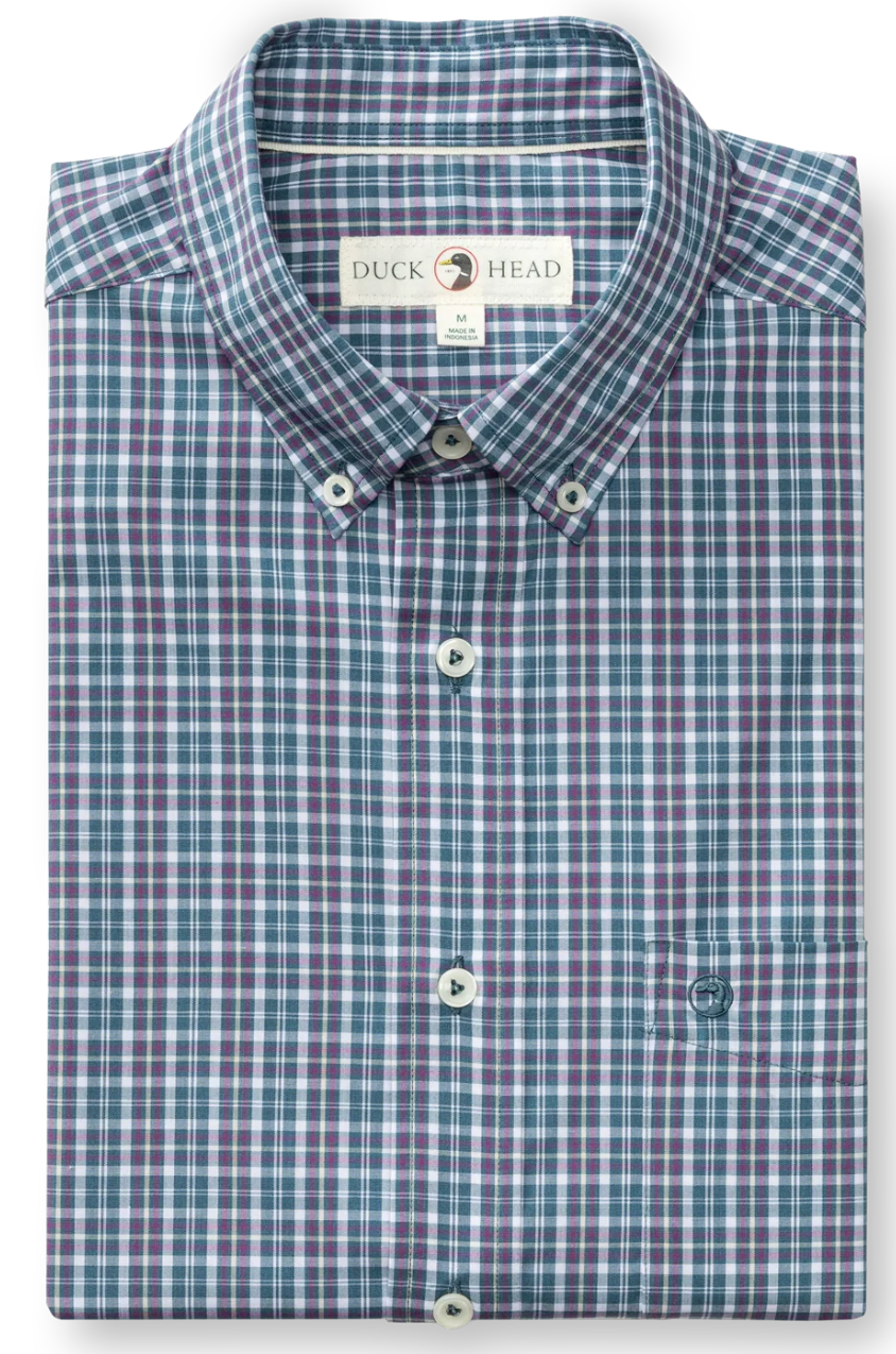 A folded long-sleeve button-down dress shirt by Duck Head, featuring a blue, purple, and white plaid pattern, displayed on a clean white background.