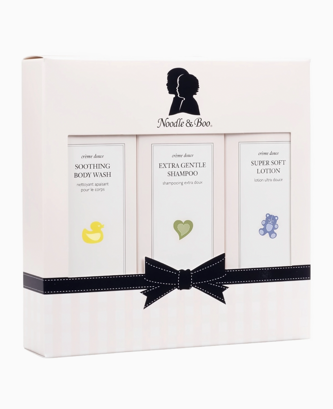 Noodle & Boo baby gift set containing three cream-based body care products: soothing body wash, extra gentle shampoo, and super soft lotion, presented in a white box with a black ribbon bow.